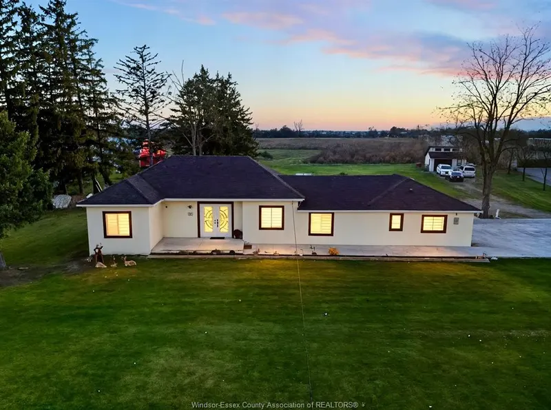 Renovated bungalow at 684 Talbot Road at dusk on a large lawn